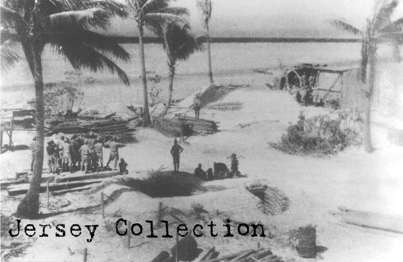 One of Betio's weapons is ready to be test fired while commanders watch. Note the sandbagged bunker in the foreground and others in the background .(National Archives).